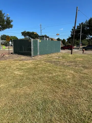 Green windscreen temporary construction fencing at a Pasadena street corner